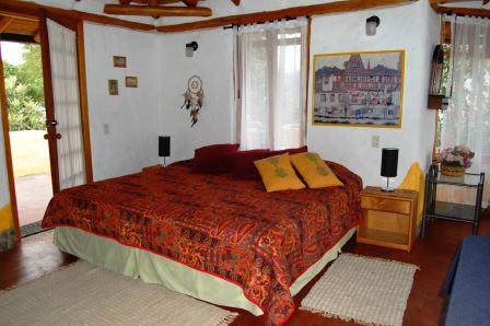 Dormitorio con cama y ropa de cama roja.